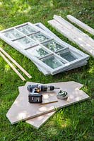 Tools and equipment gathered to make a wooden coldframe 