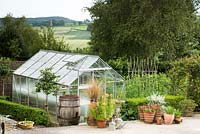 Greenhouse surrounded by pots and containers 