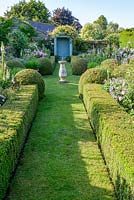 The Secret Garden with Sundial and clipped Buxus - Box hedges and balls. 
