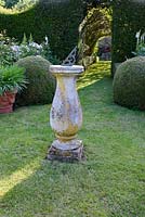 Traditional sundial in English country garden. 