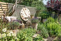 Seating area with giant wall clock and pots with lavandula