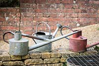 Collection of vintage watering cans. 
