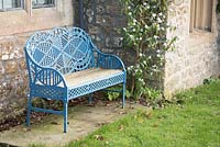 Edward Bawden-designed bench beside Daphne bholua 'Jacqueline Postill' at the Old Rectory, Netherbury, UK. 