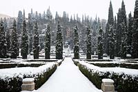 View along path of French-style parterre to avenue of Cupressus - Cypress trees and countryside beyond