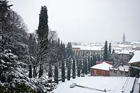 Overview of snowy formal garden - Giardino Giusti with views to the city of Verona