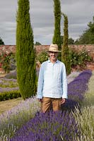 Dr Simon Charlesworth standing among lavender plants - Owner of Downderry Lavender Farm, Kent, UK. 