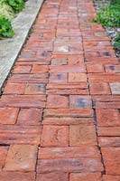 Red brick path edged with oak sleeper. 