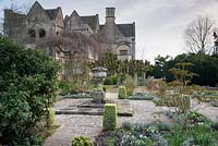 The Leisure Garden with a stone urn and variegated clipped box at its centre, Rodmarton Manor, Glos, UK.
