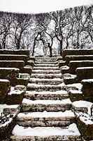 Teatro di verzura paved steps leading to stone statue in the snow