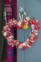 Autumnal berry wreath hanging on door knob