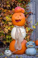 Pumpkin person made with mix of pumpkins, Acer campestre - Field Maple arms and hessian scarf, cat and mouse companions
