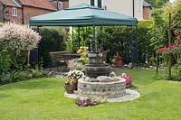 'Wishing Well' feature and gazebo in cottage garden