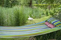 Garden hammock attached to willow tree