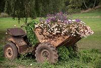 Old machinery planted with Begonia and Verbena. 
