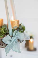 Detail of hanging advent arrangement with gold candles and Eucalyptus and Hebe foliage