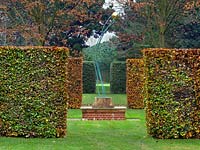 Metal artwork and hedges in autumn at East Ruston Old Vicarage Gardens, Norfolk, UK. 