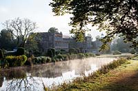 A misty early morning view of Forde Abbey seen from the Long Pond. 