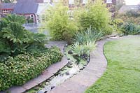 View across garden with curving water rill at Laskey Farm, Cheshire