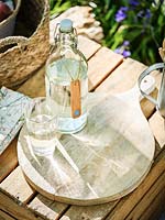Wooden bottle tag  with painted bluebell, glass bottles and glasses