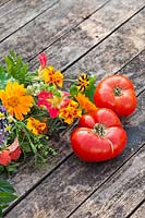 Harvested tomatoes and edible flower bouquets.