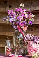 Dried flower arrangement in glass jar with Statice, Grasses, Amaranthus and everlasting flowers