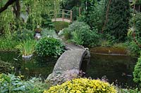 Stone bridge over the pond at Pure Land Japanese Meditation Garden