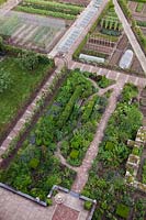 Aerial view of garden with flowerbeds and vegetable plot linked by brick and stone pathways - Holland