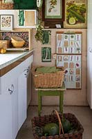 Old fashioned vintage kitchen area for vegetable preparation in garden room and baskets
