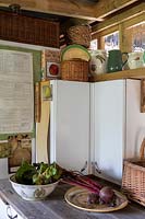 Corner of garden room with kitchen worktop and storage cupboards