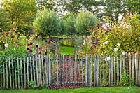 Wooden fence with an entrance to the garden.