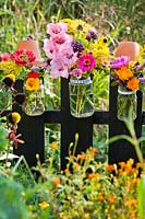 Summer flowers in glass jars - Zinnia, Coneflowers, Verbena, Solidago, Gladioli, Nasturtium, Marigolds.