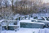 Snow-covered formal country garden.  Veddw House Garden. 