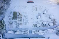 Aerial view of formal country garden covered in snow - Veddw House Garden