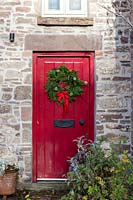 Christmas wreath on red door. 