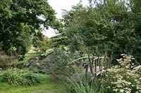 Japanese bridge over the stream - private garden at Brockhampton open for NGS