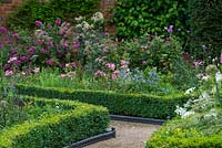 Box-edged bed planted with blue Eryngium zabelii 'Jos Eijking', Thalictrum, Roses, Lavatera trimestris 'Silver Cup' and Lavatera x clementii 'Bredon Springs'