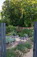 Gate in to the raised bed area with cut flowers and vegetables