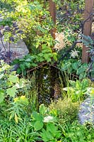 Corten steel edged water reflecting pool surrounded with naturalistic planting including Astilbe. Through Your Eyes Garden. 