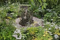 'Tumbleweed' sculpture by Jill Berelowitz on a circuitous path laid with porphyry setts, with Ammi visnaga and Ammi majus planting. The Health and Wellbeing Garden - RHS Hampton Court Palace Flower Show 2018