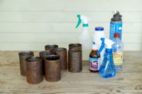 Shot of rusted tin cans with hydrogen peroxide, vinegar, table salt and blowtorch