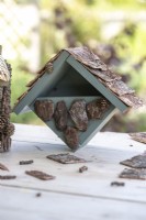 Bird house on a wooden surface