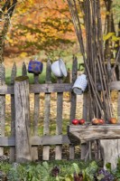 Wooden rustic fence with enamel ware.