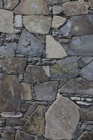 Detail of a drystone wall made of irregularly shaped split olivine basalt