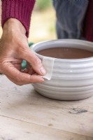 Placing masking tape over the edge of a pot