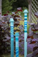 Posts in the garden surrounded by plants