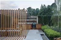 View of the pergola and outdoor kitchen hand crafted from hardwood iroko in The Viking Friluftsliv Garden with a long rill running along the path - Designer: Will Williams -Sponsor: Viking