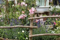 A rustic wooden fence borders the Down Memory Lane Garden - Designer and Sponsor: The Blue Diamond Design Team 