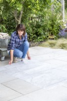 Woman placing plastic sheet on the ground