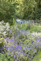 Border of blue and white flowers and view to the metal dragon railings