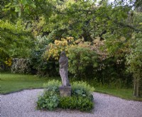 A carved stone statue on a plinth in the Lady Gardens 
